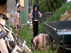 Dark haired German lady making her slaves chop wood