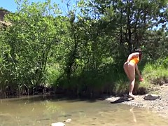 Brunette teen Jenny rubs pussy at the lake