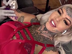 Alternative girls pussy is masturbated during a tattoo session