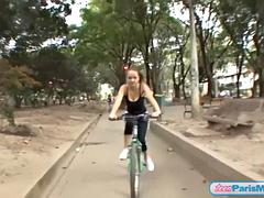 Busty solo teen riding her bike through the park