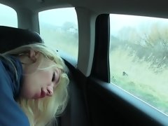 A blonde with big boobs is getting fucked in the back of a car
