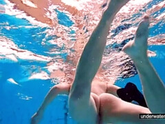 Teen girl Avenna is swimming in the pool