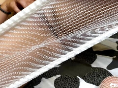 Brunette in a fishnet playing with her slit