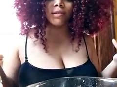 Hand expressing milk from huge ebony tits