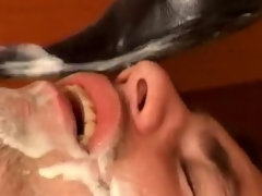 Leashed slave boy eating milk from his goddess boots